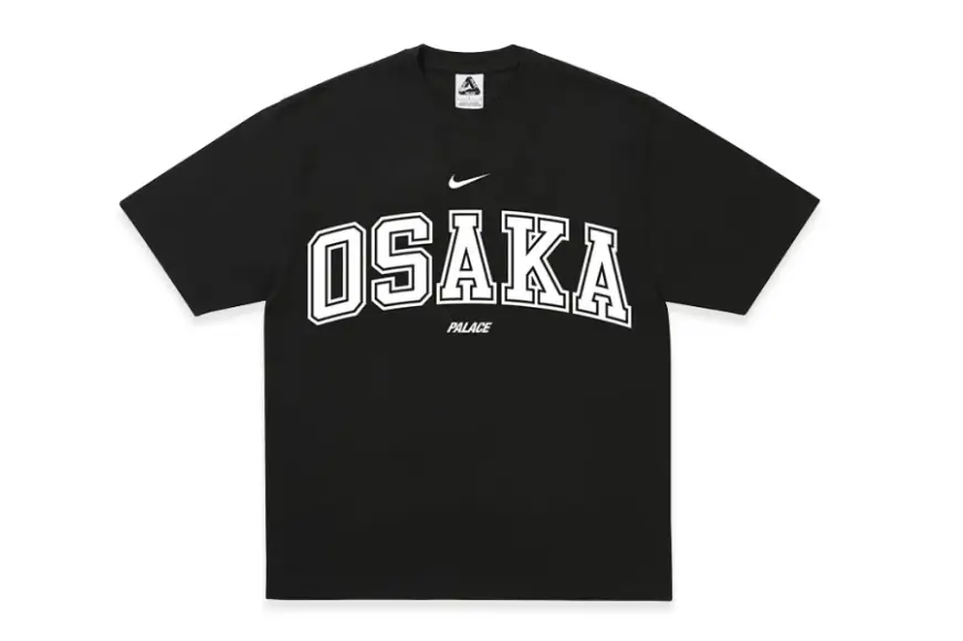 Black Nike x Palace Osaka T-shirt featuring oversized varsity-inspired "OSAKA" lettering in white across the front, with a Nike Swoosh above and Palace branding centered below the graphic