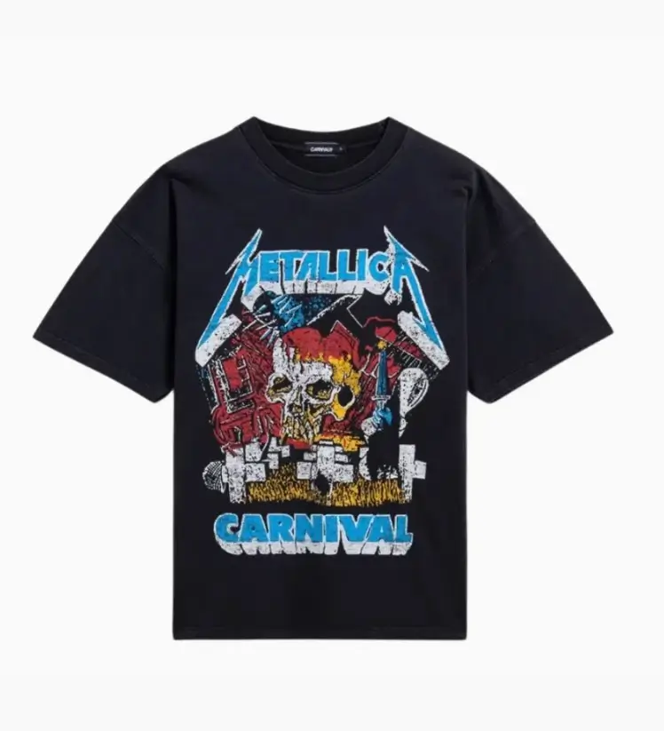 Front view of a black short sleeve T-shirt featuring a distressed Metallica Carnival graphic. The oversized front print combines the classic blue Metallica logo with a skull, carnival inspired illustrations, and bold blue 'Carnival' lettering against a clean white background.
