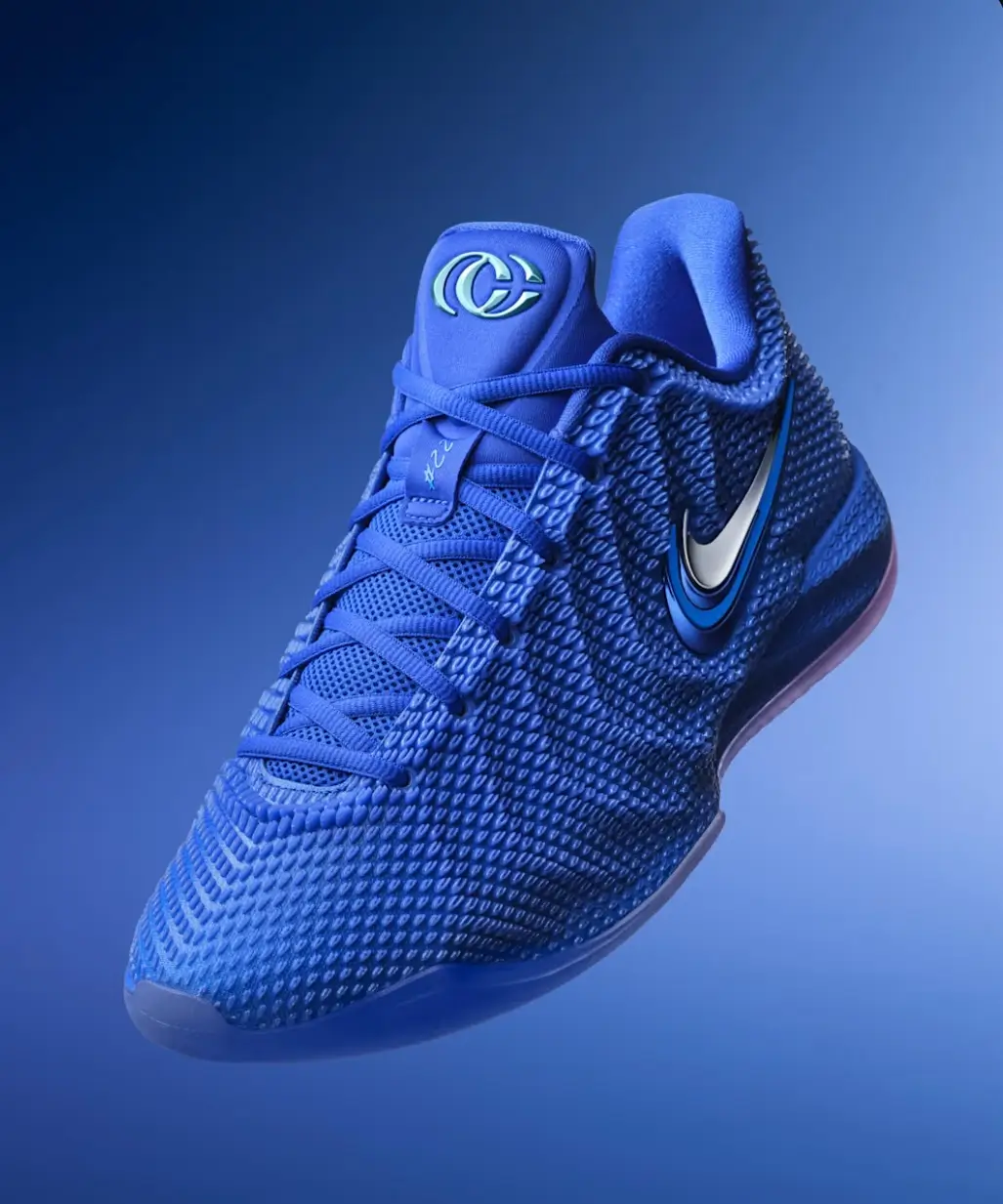 Nike Giannis Freak 7 basketball shoe in a vivid royal blue colorway, featuring a textured engineered upper, tonal laces, metallic silver Swoosh with blue outline, sculpted midsole, and Giannis logo on the tongue against a matching blue gradient background.