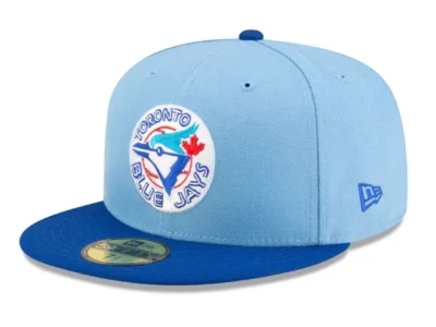 Light blue Diet Starts Monday x New Era Toronto Blue Jays fitted cap with a vintage Blue Jays circular logo on the front, a royal blue flat brim, matching top button, and embroidered New Era flag on the side.