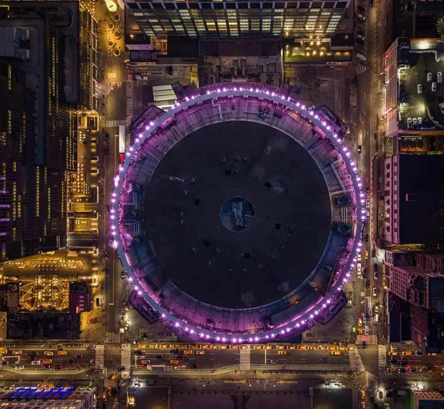 Top-down aerial view of Madison Square Garden illuminated at night