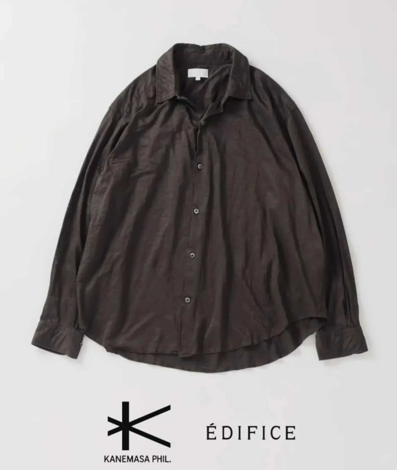 Dark brown oversized button-up shirt created for the KANEMASA PHIL. × ÉDIFICE collaboration, featuring a lightweight subtly textured fabric, spread collar, tonal button closure, dropped shoulders, long sleeves with buttoned cuffs, and a relaxed curved-hem silhouette.