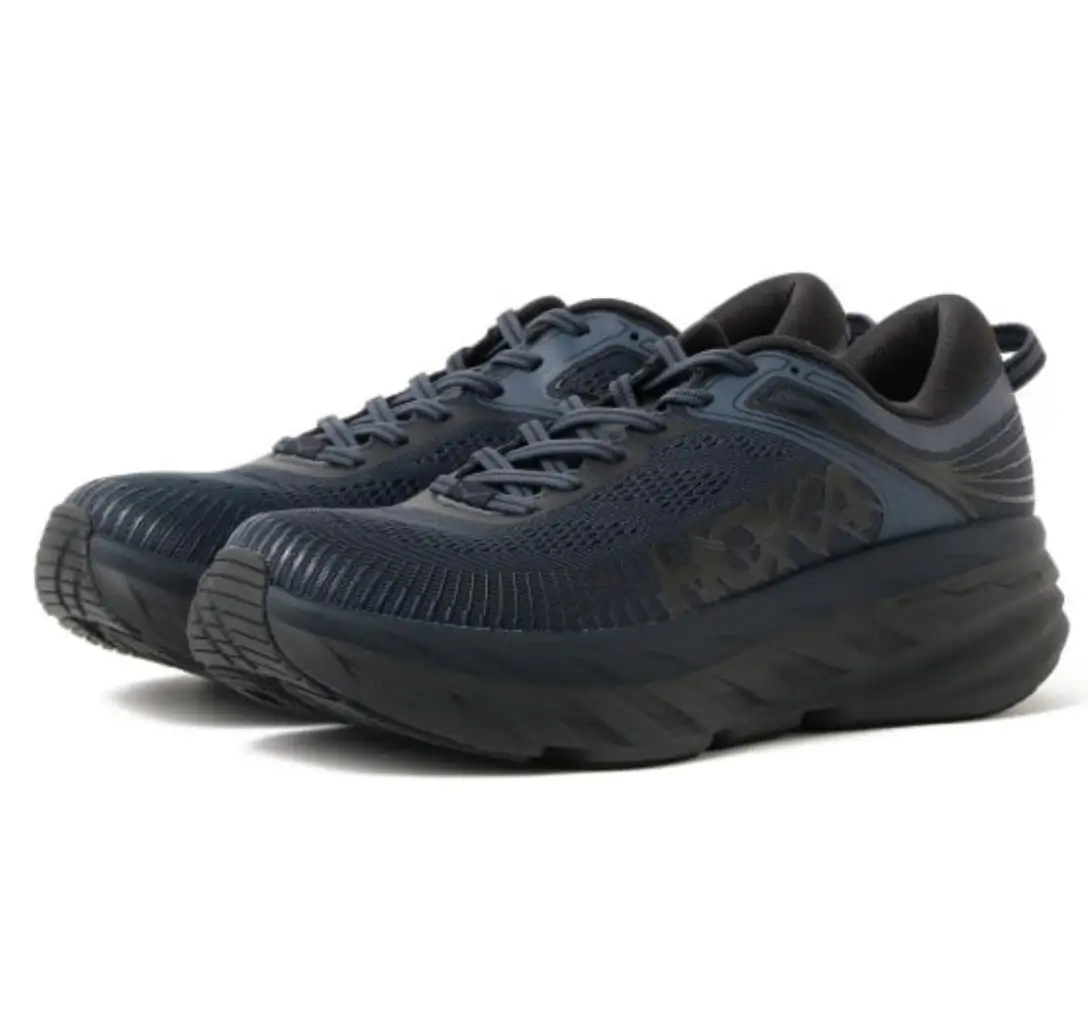 Navy HOKA Project Transport shown in an angled three-quarter view, featuring a breathable engineered mesh upper, tonal overlays, subtle camouflage HOKA branding, and a chunky sculpted performance midsole.