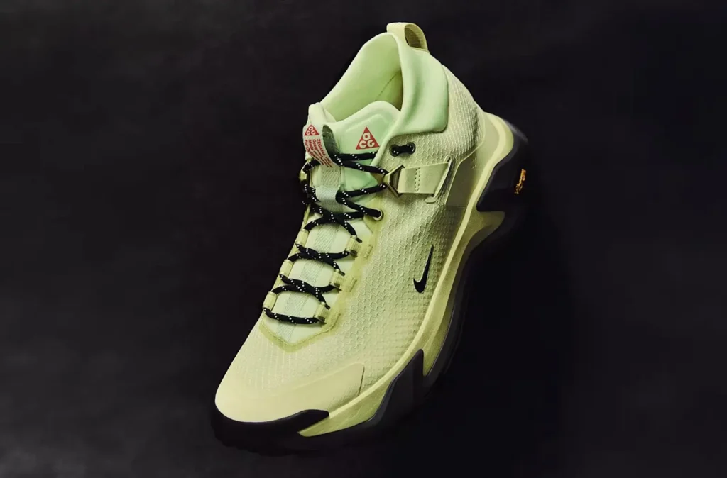 Three-quarter front view of the Nike ACG Zegama Hike in pale volt, featuring a textured upper, black trail outsole, ACG tongue branding, and technical hiking design