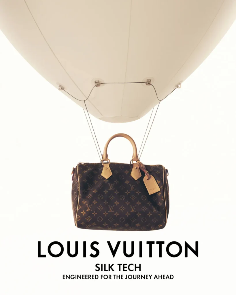 Louis Vuitton Speedy handbag suspended beneath a white helium balloon, creating a whimsical campaign image emphasizing lightweight travel and the Silk Tech collection