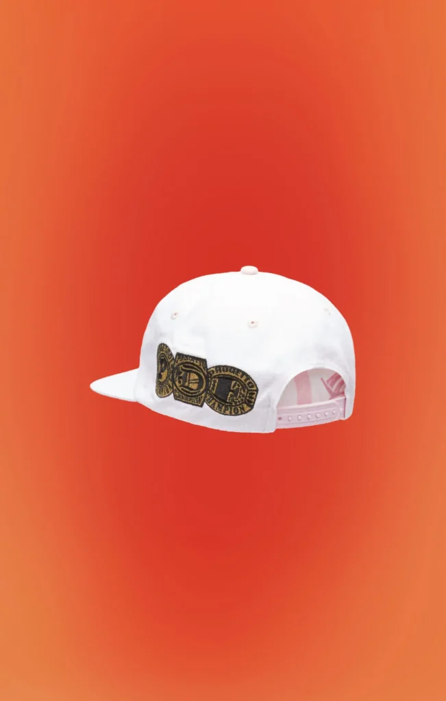 Rear view of the white snapback cap showcasing embroidered championship belt graphics, an adjustable pink snap closure, and tonal white crown with stitched eyelet