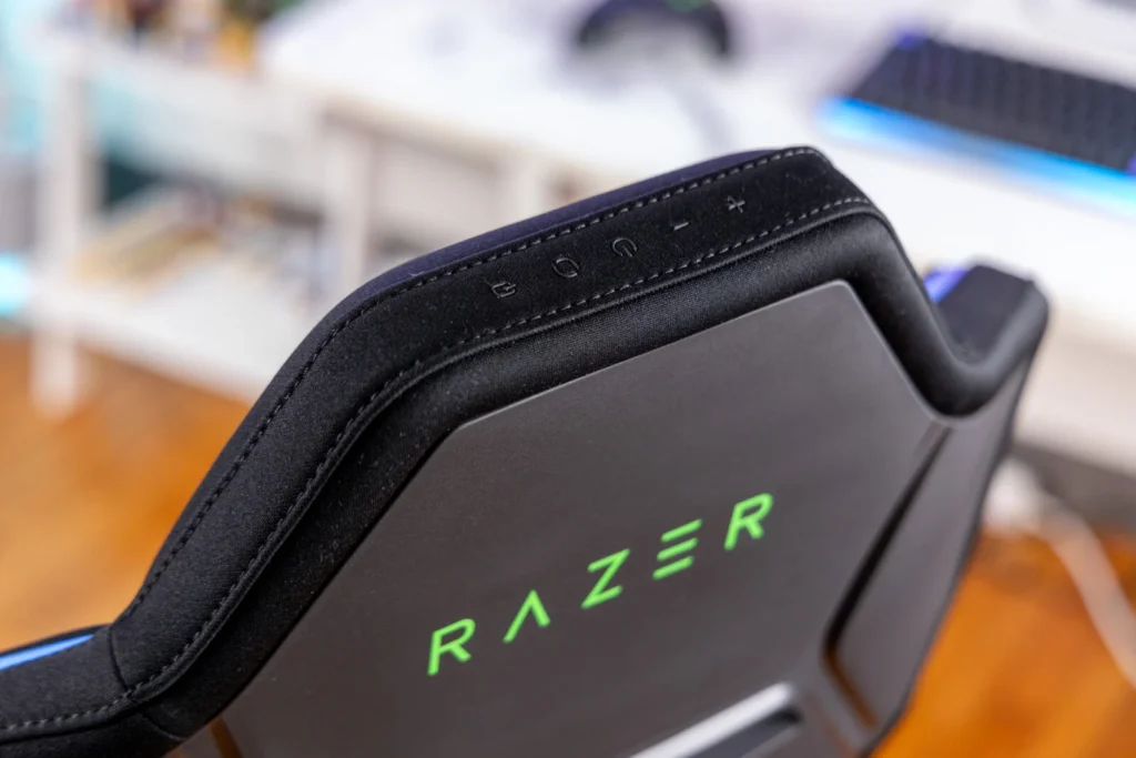 Close-up of the Razer gaming chair headrest featuring integrated control buttons for RGB lighting and power function