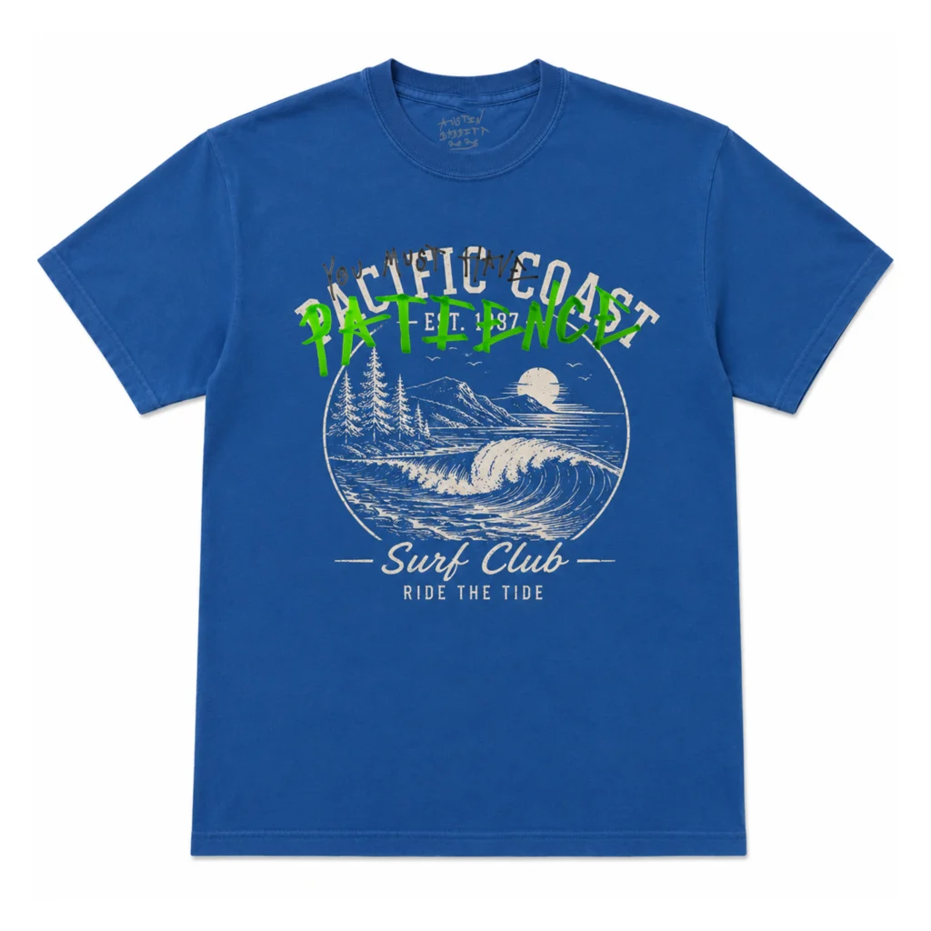 Royal blue Tee featuring a retro surf club landscape graphic with waves and mountains, layered beneath a handwritten "You Must Have PATIENCE" message in black and green