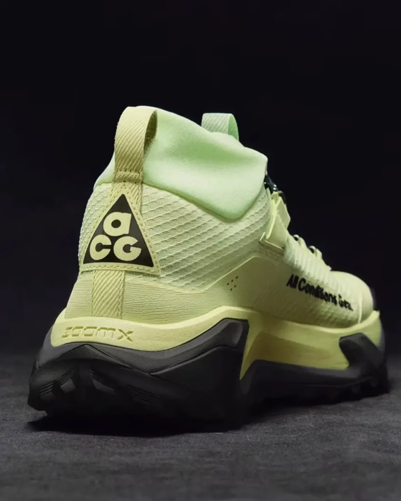 Rear three-quarter view of the Nike ACG Zegama Hike in pale volt, showcasing the ACG heel logo, ZoomX cushioning, and aggressive Vibram trail outsole