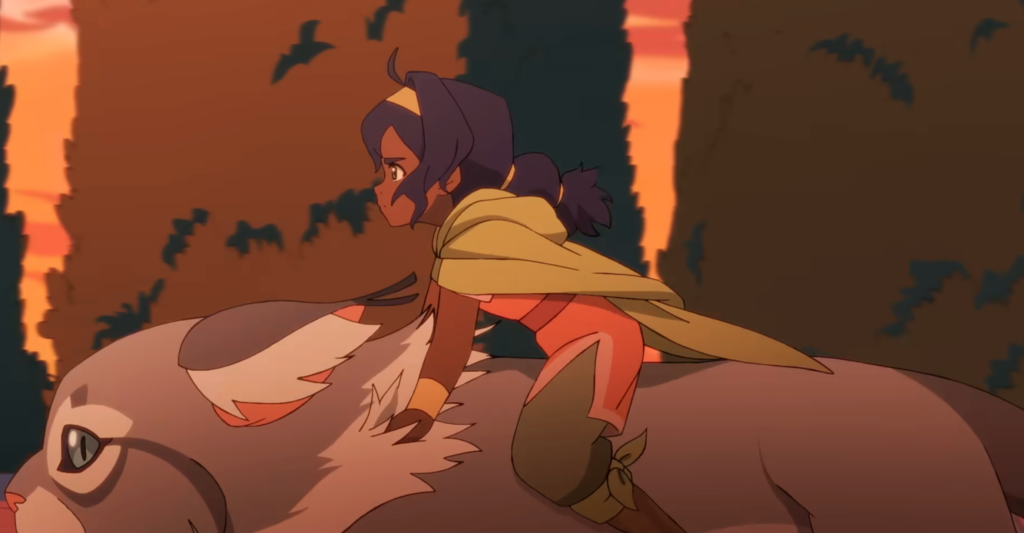 Animated scene showing Pavi riding a massive white, cat-like creature through towering hedges at sunset. Wearing a green cape and coral outfit, she leans forward with determination as birds fly overhead against a glowing orange sky, capturing a sense of urgency and adventure