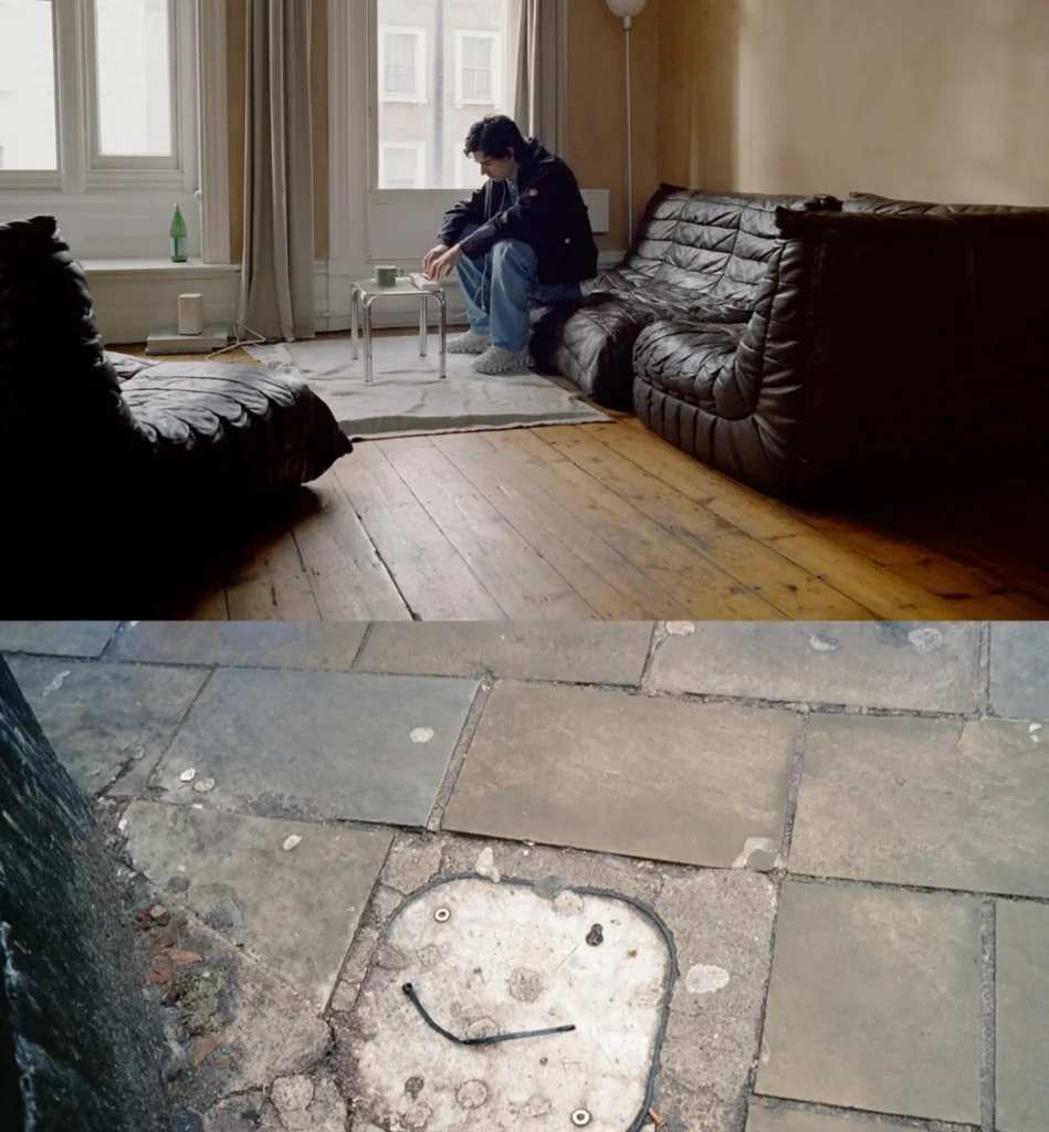 Split-frame street portrait of a male model in layered neutral workwear walking along wet pavement, followed by a rear view of him seated at a café table in a red and blue striped hoodie