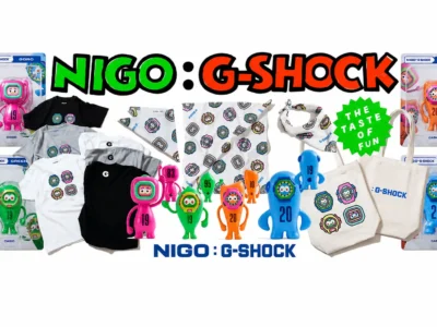 Complete NIGO x G-SHOCK collision lineup featuring graphic T-shirts, bandanas, tote bags, collectible mascot figures, stickers, and packaged character toys arranged in a colorful promotional display