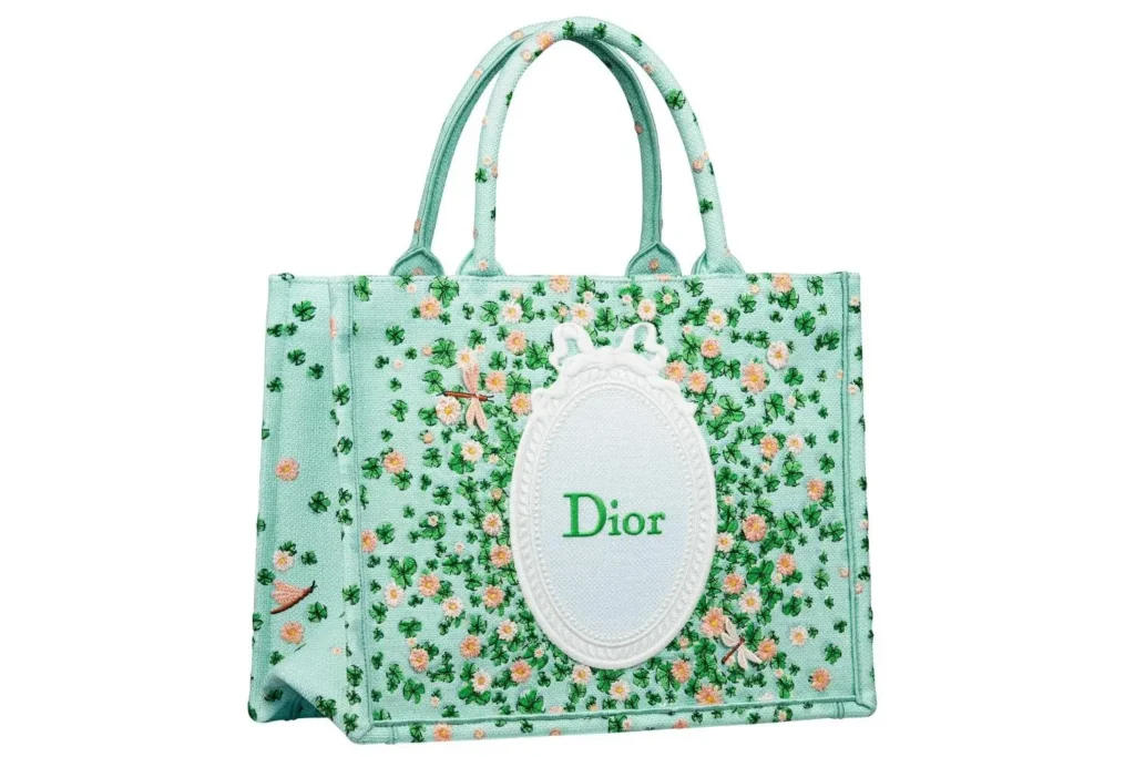 Mint green Dior Book Tote embroidered with clover and floral motifs, featuring an oval Dior logo panel and structured top handle