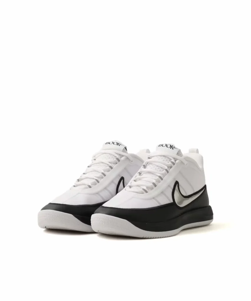 Three-quarter angled view of the Nike BOOK Chapter Two sneakers emphasizing the streamlined basketball-inspired silhouette, metallic Swoosh, and black-and-white tincture block
