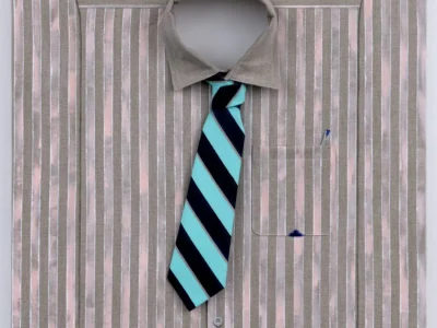 Large trompe-l'œil artwork depicting a striped beige dress shirt with a turquoise-and-navy diagonal striped tie, carefully rendered seams, cuffs, buttons, and a pen tucked into the chest pocket
