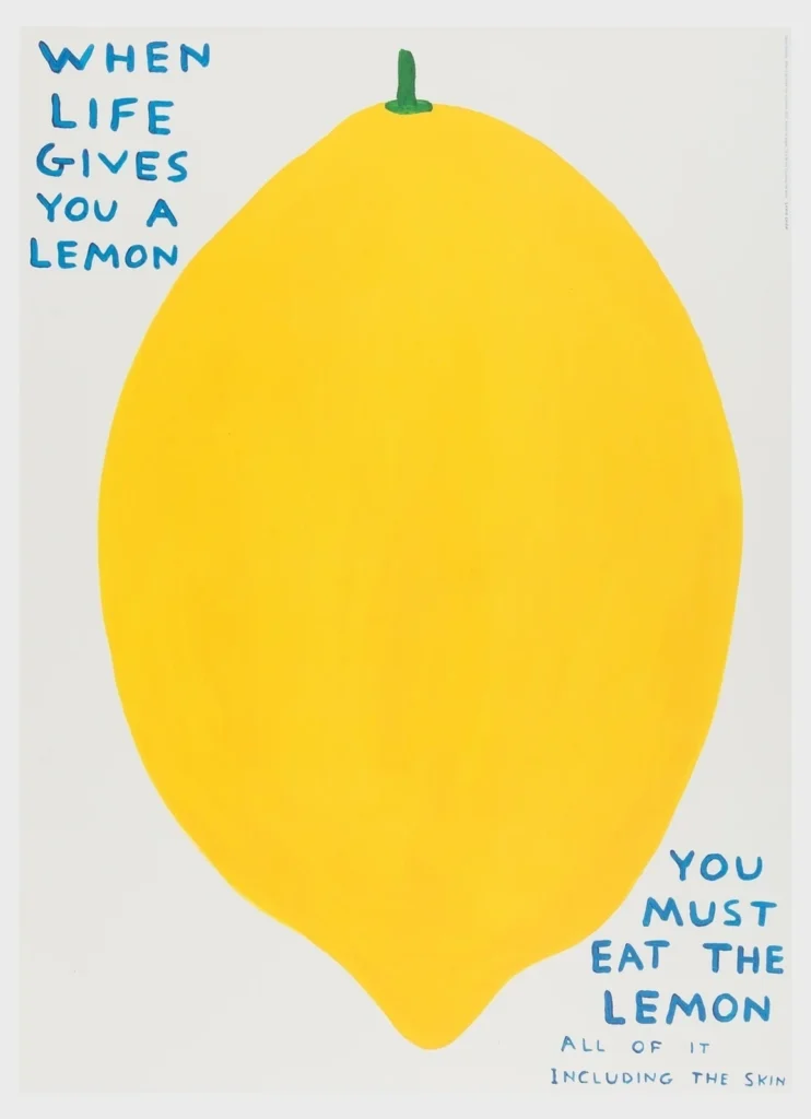 A minimalist poster on a white background featuring an oversized, hand-painted yellow lemon centered on the page with a small green stem. In blue, handwritten uppercase text at the upper left reads, “WHEN LIFE GIVES YOU A LEMON.” At the lower right, matching blue text continues, “YOU MUST EAT THE LEMON,” followed by smaller text beneath that says, “ALL OF IT INCLUDING THE SKIN.” The play illustration uses flat colors and a naïve, graphic style with generous white space surrounding the large fruit