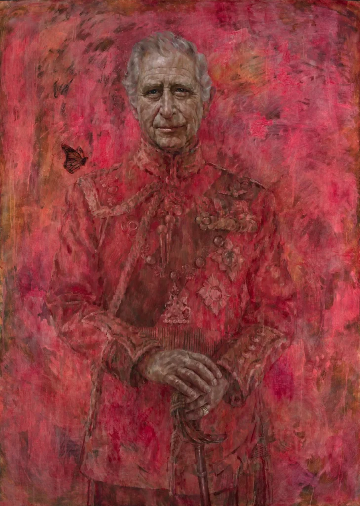 A richly textured portrait painting depicts King Charles III in a ceremonial military uniform rendered almost entirely in deep crimson and rose tones. He stands facing forward with his hands resting on a sword, royal medals and insignia blending into the expressive brushwork, while a single butterfly hovers beside his shoulder against the abstract red background