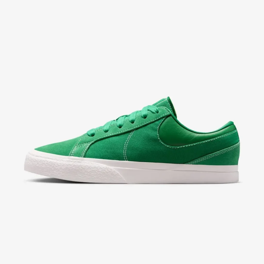 Side profile of a bright green Nike low top shoe featuring a canvas and suede upper, padded leather heel collar, tonal laces, contrast white stitching, and a white vulcanized sole