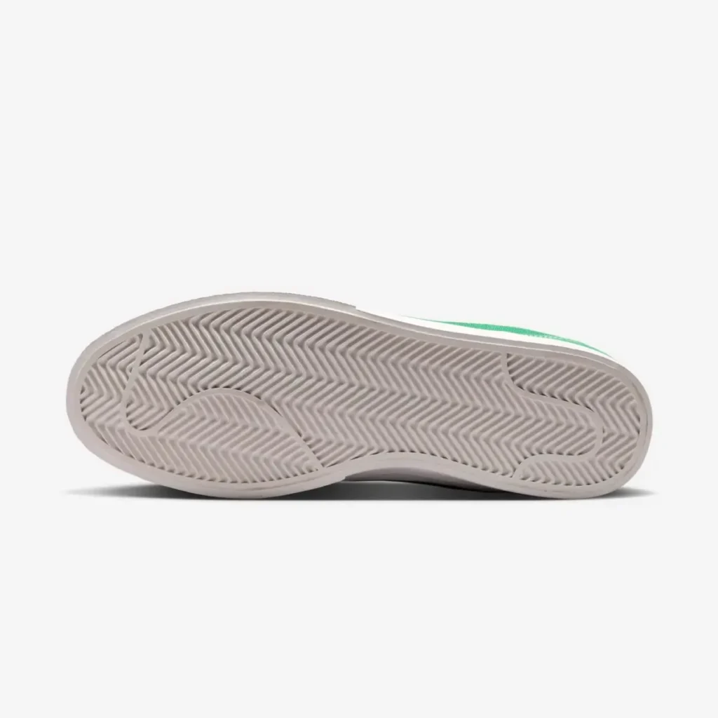 Bottom view of the Nike shoe highlighting the full-length herringbone rubber outsole with a wavy traction pattern in off-white