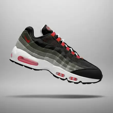 Nike Air Max 95 Big Bubble 'Solar Red' sneaker featuring a black mesh upper, gradient grey suede overlays, bright Solar Red lace loops and Swoosh, oversized visible Air cushioning, and an off-white midsole.