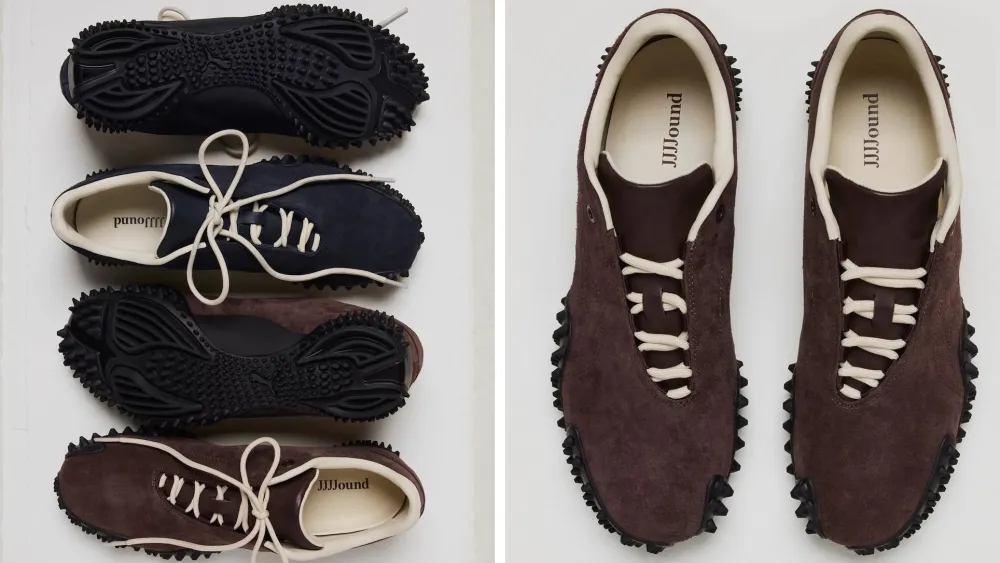 Top-down comparison of the JJJJound x Puma Laced Mostro in Deep Navy and Dark Chocolate suede, highlighting the minimalist lace closure, cream leather lining, JJJJound branding, and the signature black spiked Mostro outsole.