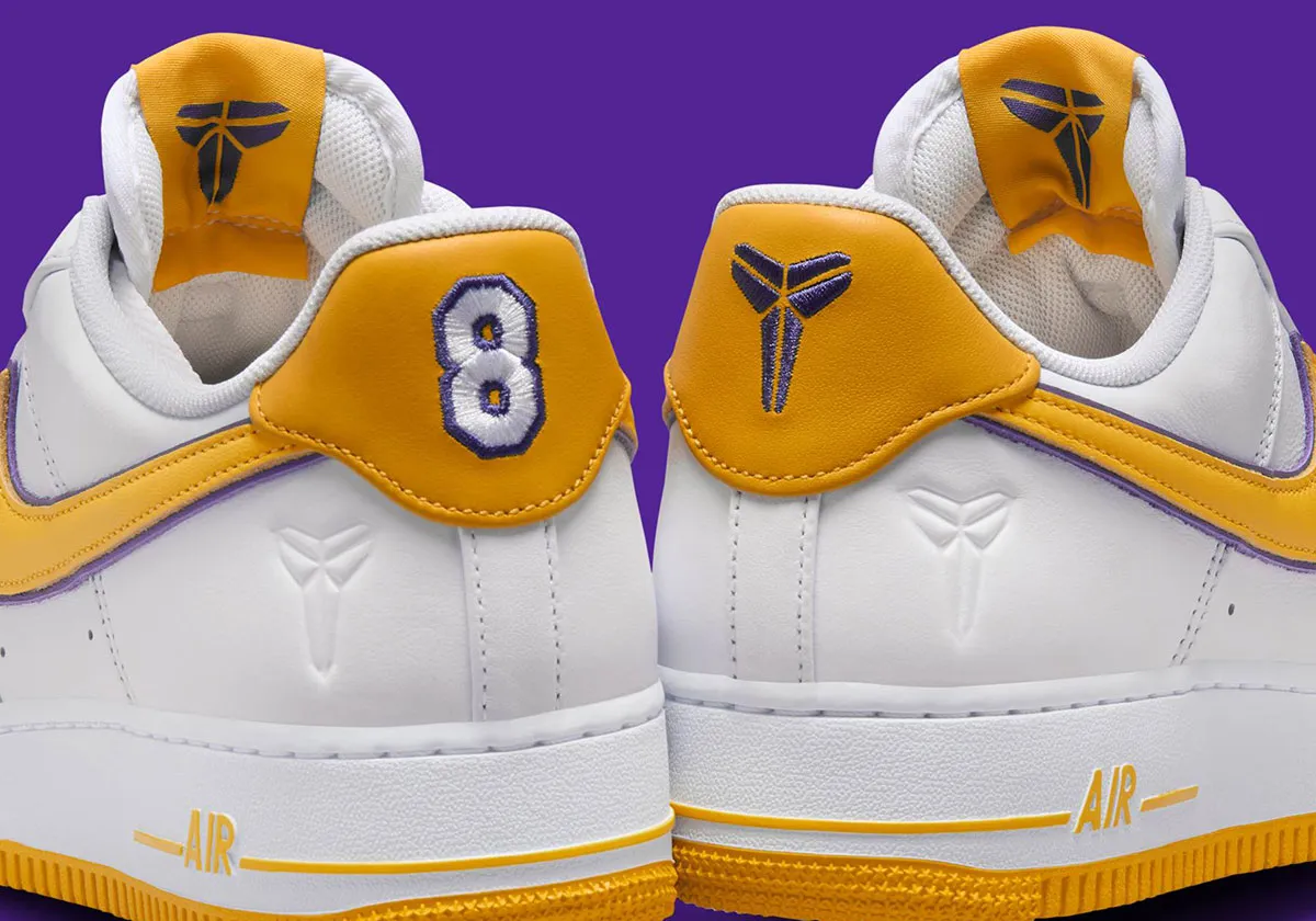 Rear view of the Kobe Bryant x Nike Air Force 1 Low Protro featuring white leather construction, gold heel tabs with embroidered number 8 and Kobe Sheath logo, purple trim, embossed heel logos, and a yellow rubber outsole inspired by the Los Angeles Lakers.