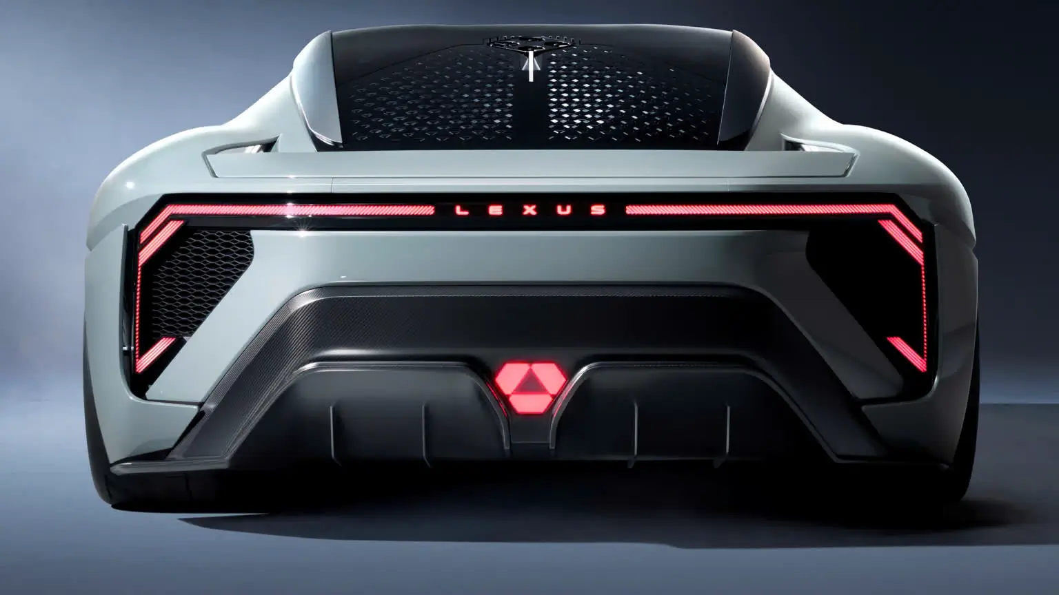 Rear view of the Lexus Electrified Sport concept featuring a full-width LED light bar, illuminated LEXUS lettering, angular taillight signature, vented rear deck, integrated spoiler, and sculpted aerodynamic diffuser finished in metallic silver.