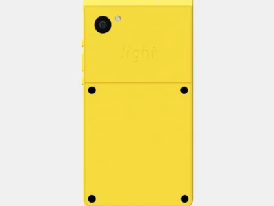 Rear view of the yellow Light Phone showing its single camera, flash, embossed Light branding, and flat industrial design on a light gray background