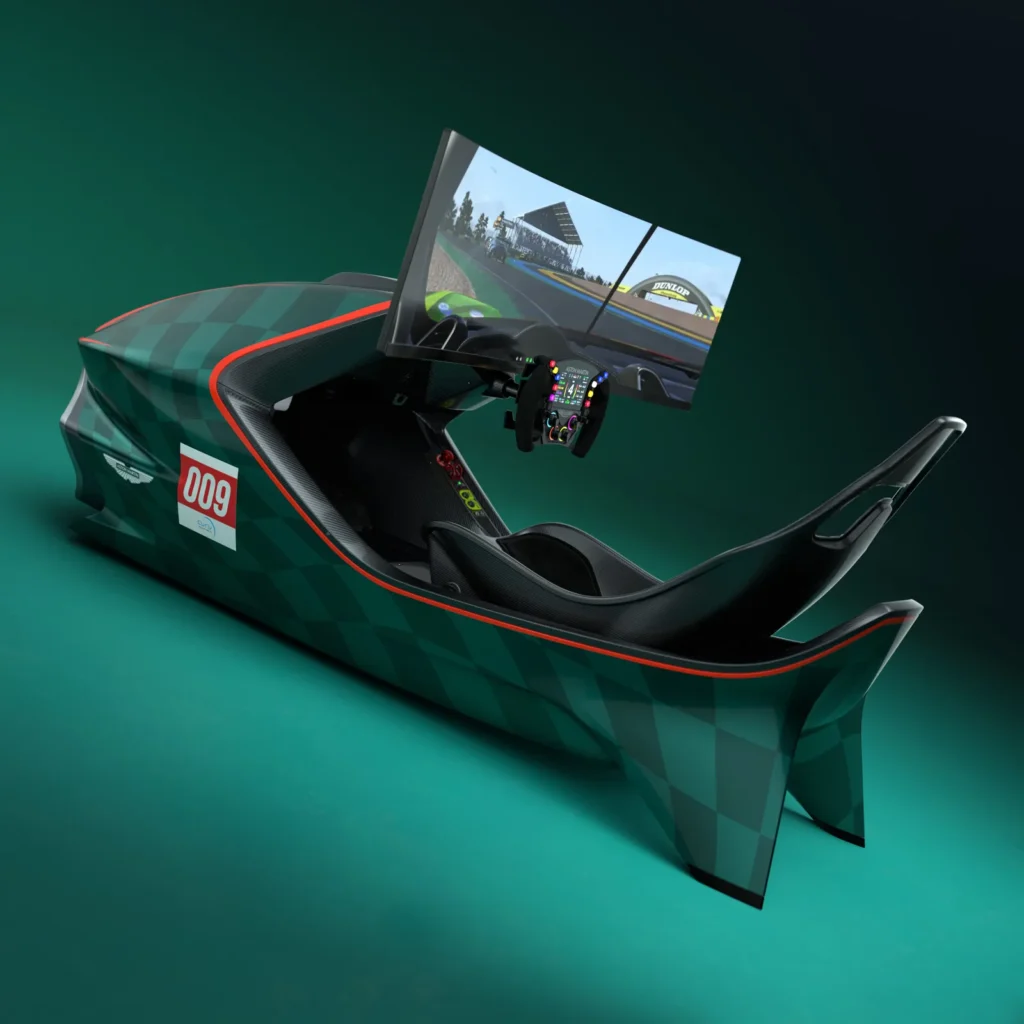 Rear three-quarter view of an Aston Martin-inspired racing simulator with a sculpted racing seat, Formula-style steering wheel, curved ultrawide monitor displaying a racing simulation, and a sleek green body accented with red trim