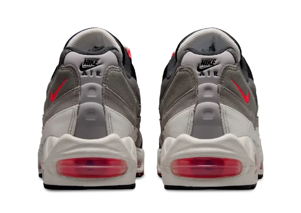 Rear view of the Nike Air Max 95 Big Bubble "Solar Red" displaying Nike Air heel branding, reflective grey heel tabs, Solar Red embroidered Swooshes, oversized visible Air units, and off-white mid