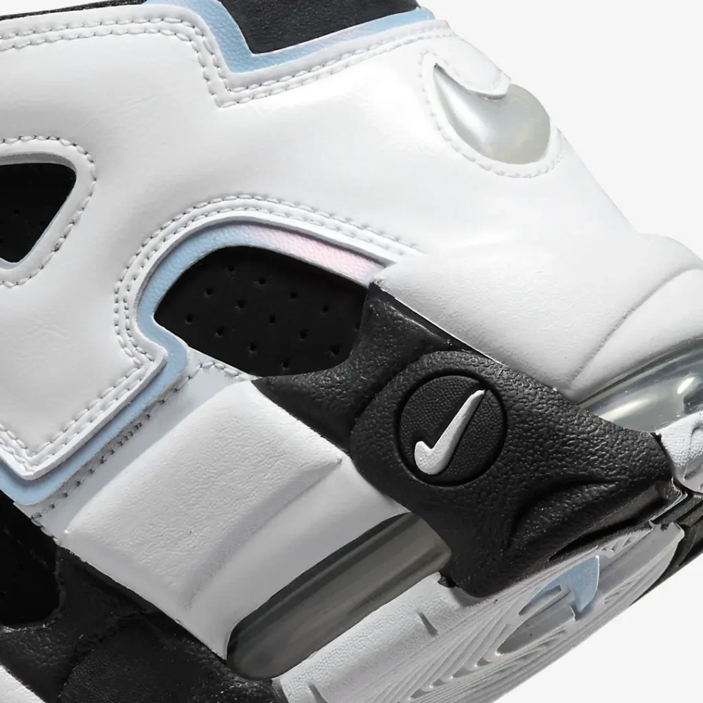 Close-up of the lateral heel showcasing the view Air unit, black molded support piece with mini silver Swoosh, white leather paneling, and iridescent blue edge trim