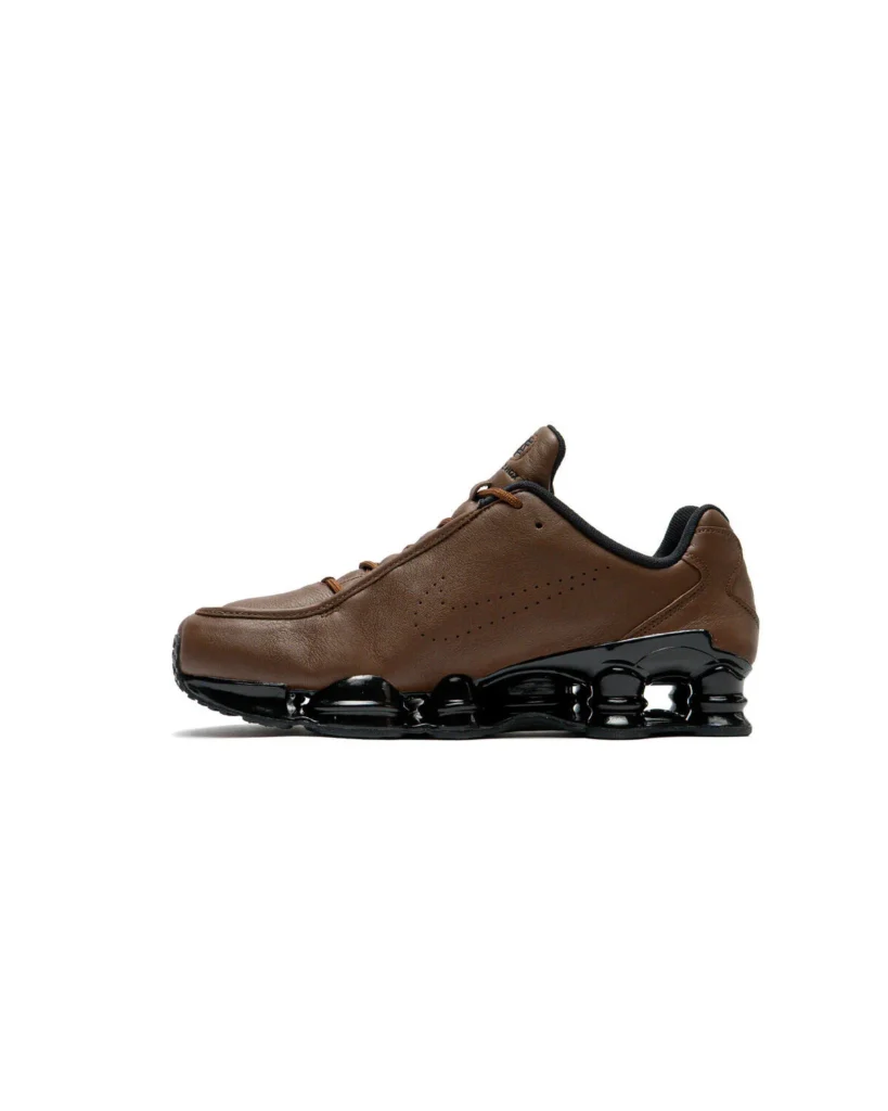 Opposite lateral view of the Nike Shox TL SE "Cacao Wow" showcasing its smooth brown leather construction, subtle perforated Swoosh branding, sculpted black Shox midsole, and black rubber outsole against a clean white backdrop