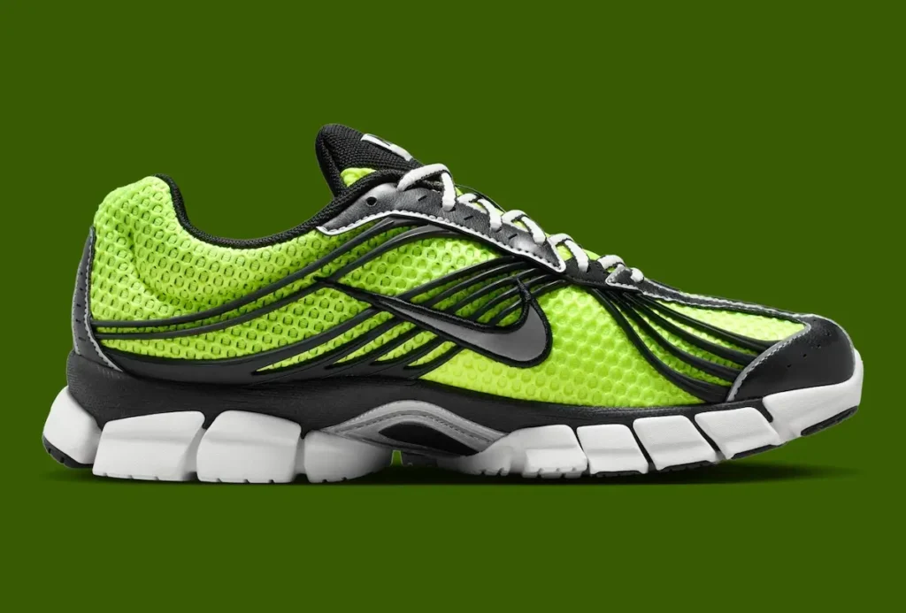 Medial side profile of the Nike Zoom Skylon 11 featuring volt mesh construction, black flowing support overlays, sculpted white segmented cushioning, silver midfoot detail, and black rubber traction