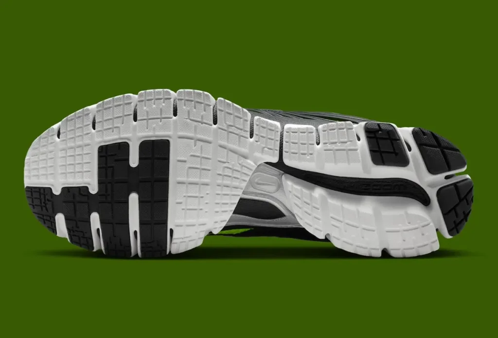 Bottom view of the Nike Zoom Skylon 11 showing a white segmented rubber outsole with black traction pods, flex grooves, and a black midfoot Zoom support shank