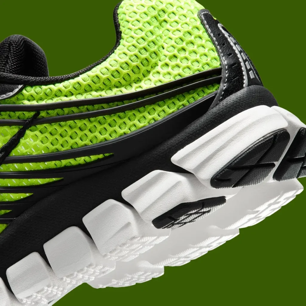Detailed close-up of the Nike Zoom Skylon 11 heel displaying volt open-mesh construction, black TPU support cage, textured black midsole, white segmented Zoom cushioning, and black rubber outsole