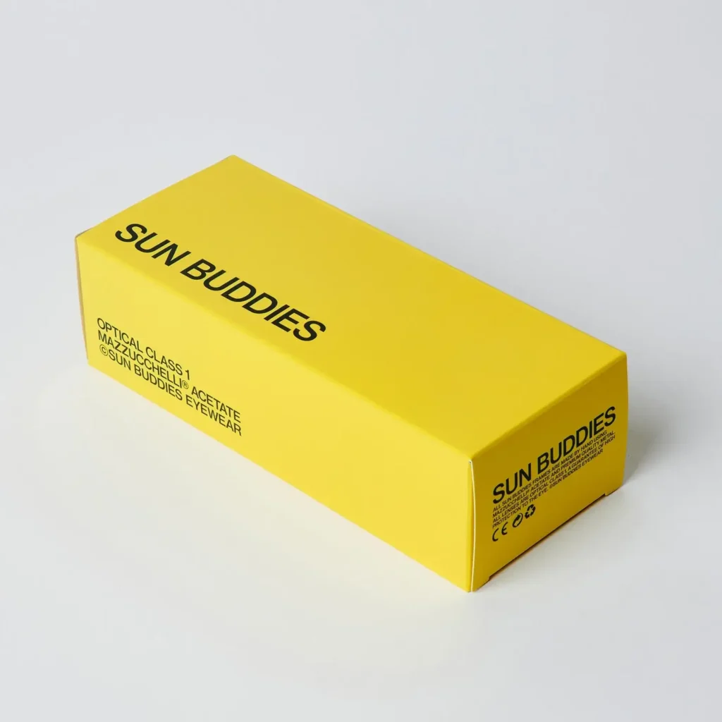 Bright yellow Sun Buddies eyewear box with bold black branding and product detail