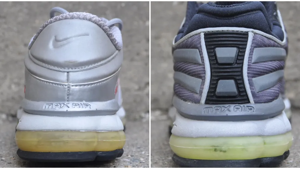 Side-by-side comparison of two Nike Air Max 2000 heel designs. The left shoe features a smooth metallic silver leather heel with an embossed Nike Swoosh, 'MAX AIR' branding above a yellowed visible Air unit, and minimal paneling. The right shoe has a more technical heel construction with ribbed black TPU support, grey overlays, striped textile panels, 'MAX AIR' branding, and a similarly aged visible Air cushioning unit, highlighting the evolution between the two versions.