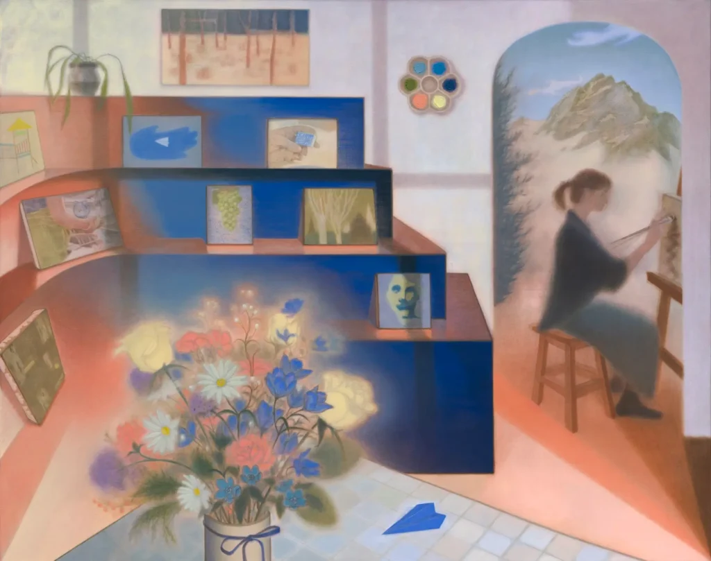 Contemporary artist's studio with colorful floral arrangement, framed paintings, abstract artworks, and a painter working at an easel beside an arched window overlooking distant mountain
