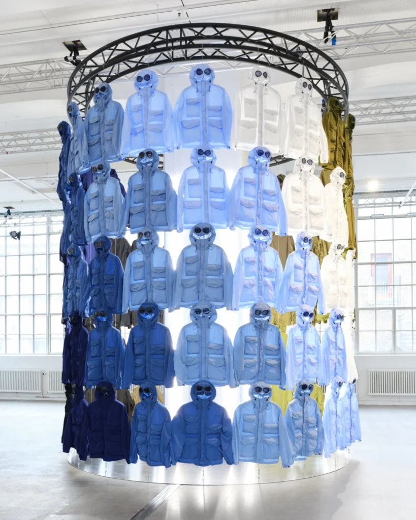 Large circular install filled with C.P. Company goggle jackets in shades of blue, white and olive
