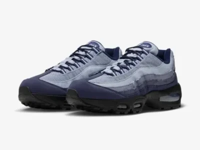 Three-quarter front view of the Nike Air Max 95 pair showing the layered gradient upper, black sole, visible Air units, and streamlined sil