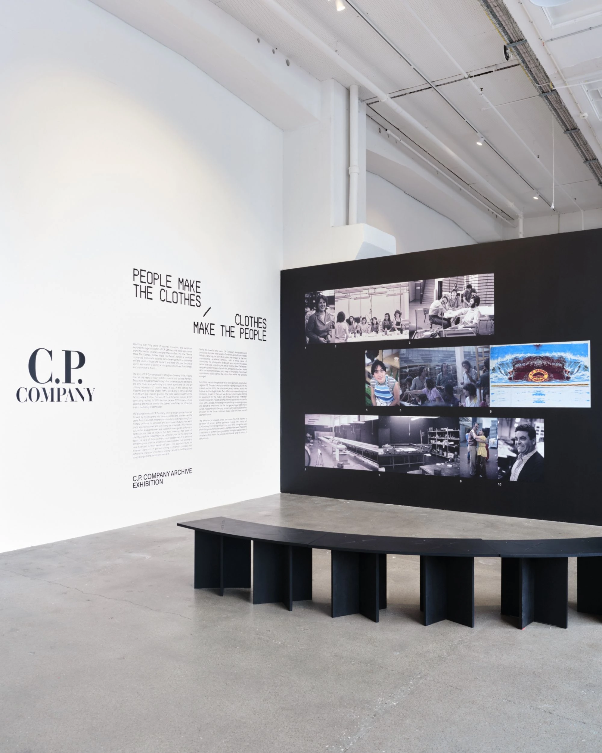 C.P. Company archive exhibition with historical photographs, wall text reading People Make the Clothes, Clothes Make the People, and a curved black bench.