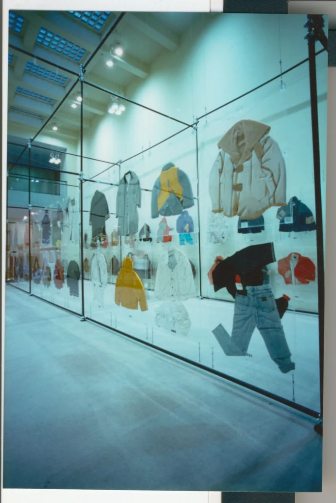 Archival photograph glass grid showcase assemble for a C.P. Company exhibition display garment