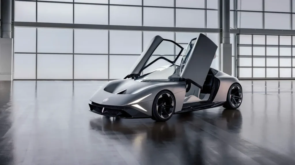 Acura NEXERA Vision shown from the front three-quarter angle with both dramatic upward-open doors raise inside a modern glass-wall studio