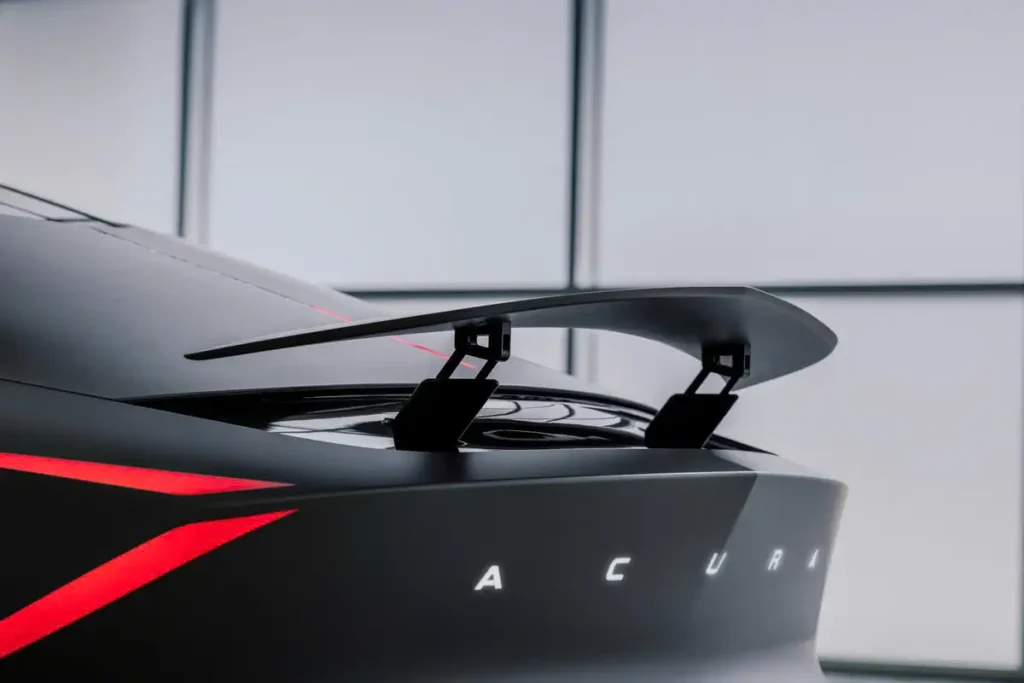 Close-up of the Acura NEXERA Vision rear wing, sculpt matte bodywork, illuminate Acura letter, and sharp red taillight graphic