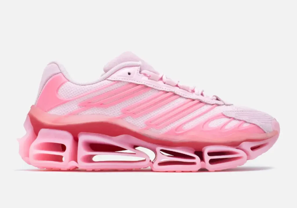 Side profile of the pink adidas x Willy Chavarria shoe featuring layered mesh and suede panels, sculpt Three Stripes overlays, oversized hollow midsole cushion, and tonal pink detail