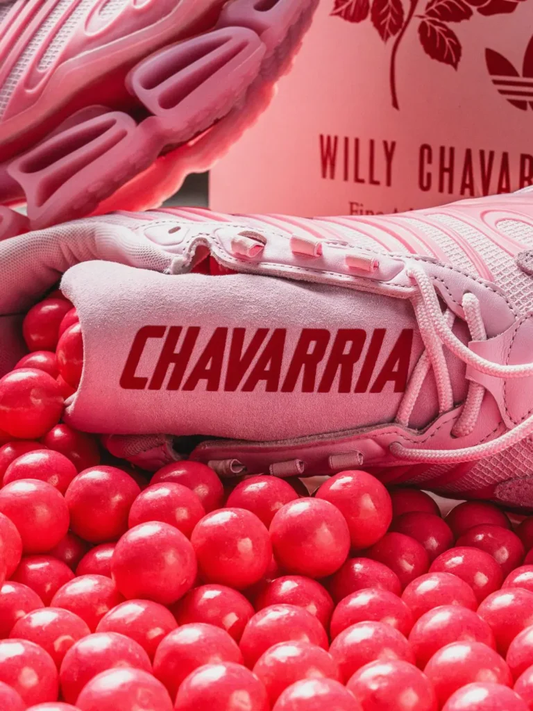 Close-up of the CHAVARRIA-branded suede tongue resting among red gumballs with the connective shoebox view in the background