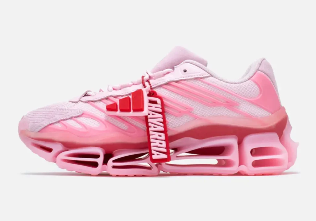 Lateral view of the adidas x Willy Chavarria shoe featuring the removable red adidas and Chavarria co-branded hangtag, layered pink upper, and oversized cushion sole