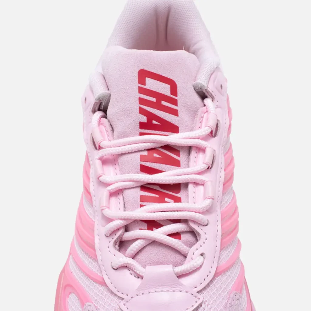 Close-up of the suede tongue feature oversized red CHAVARRIA brand, pale pink rope laces, and padded collar construction