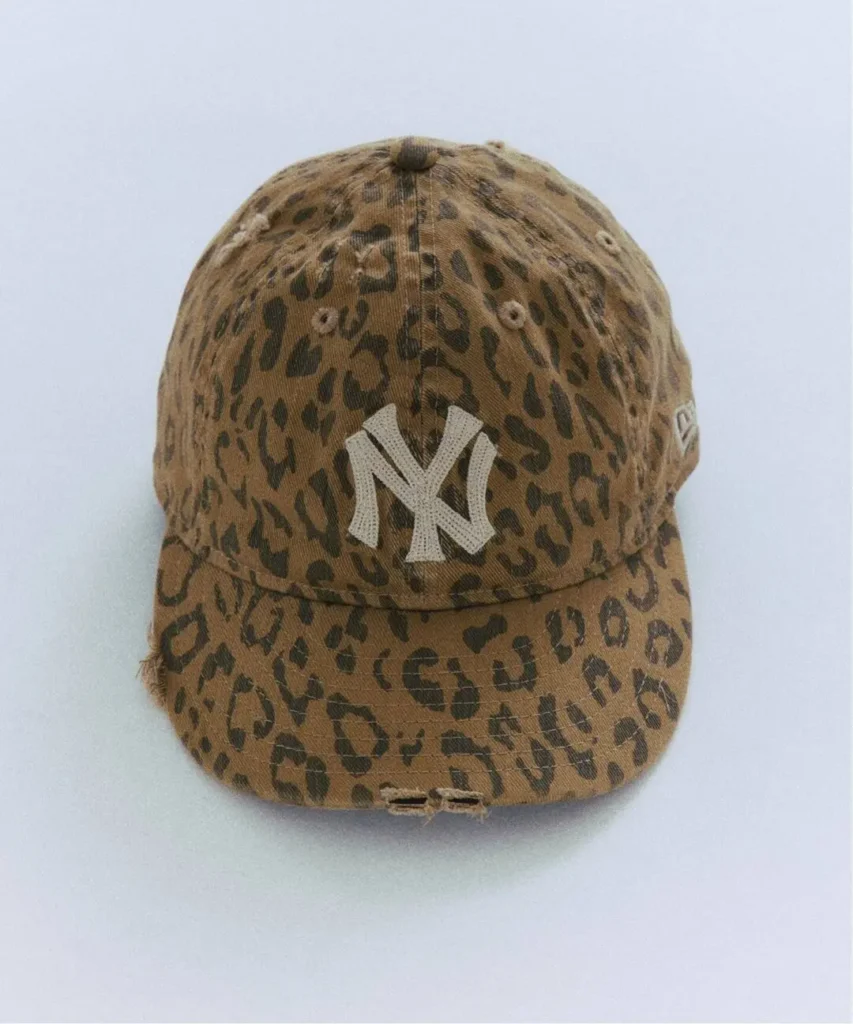 Leopard-print baseball cap with a white New York Yankees logo, shown against a pale background