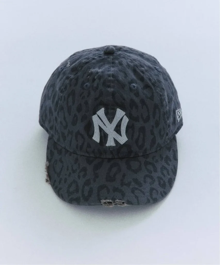 Dark leopard-print New York Yankees cap with a white logo and frayed brim, centered on a pale background